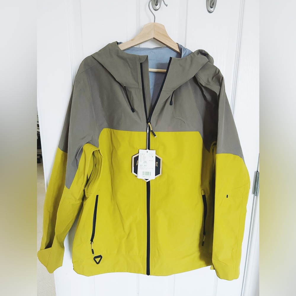 An Ta windbreaker jacket with two pockets 2XL size yellow and grey color